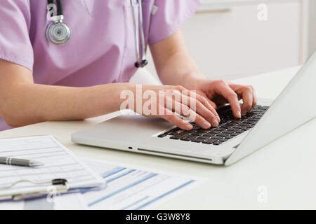 Female doctor working on laptop Stock Photo