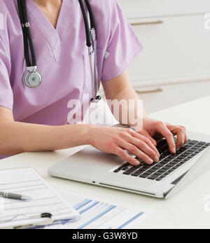 Female doctor working on laptop Stock Photo