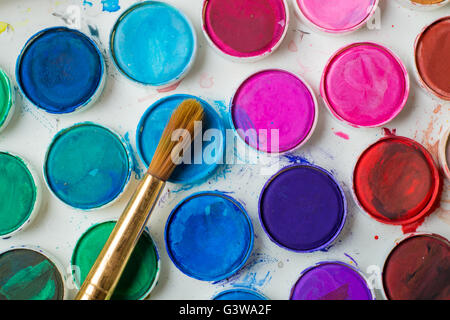 Close-up of water-color paint-box and paint brush. Stock Photo
