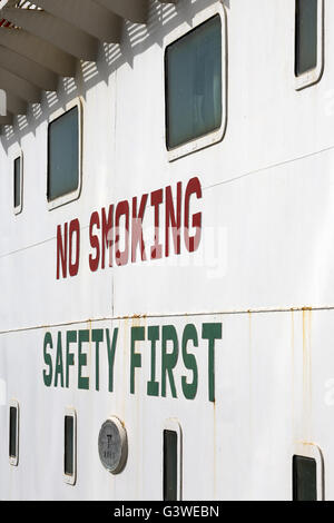 Safety sign on Oil tanker supplying fuel oil (bunkers) to Passenger ship. Port of Dubai .UAE Stock Photo