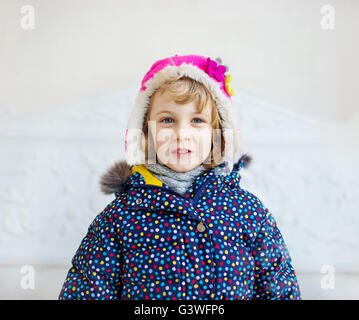 Portrait of happy girl wearing winter hat and coat Stock Photo