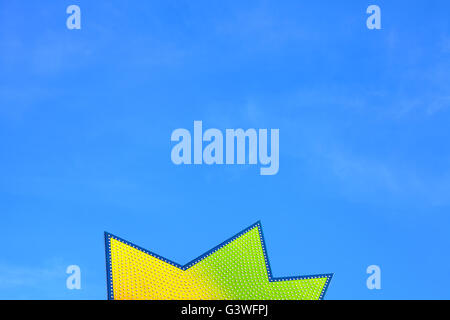 Star shape board with bulbs against blue sky, abstract background. Stock Photo