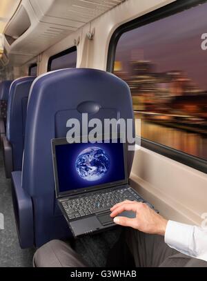 man working on a laptop in the train Stock Photo