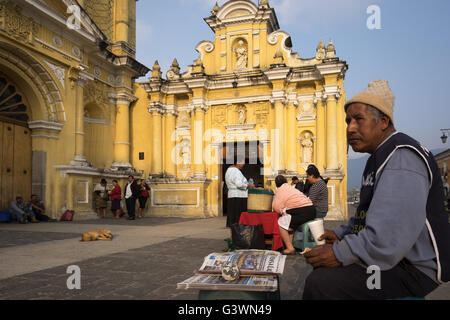 A man sells lottery in front of the Church of St. Pedro Apostol in Antigua. Stock Photo