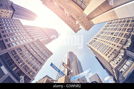 Vintage stylized fisheye lens photo of skyscrapers in Manhattan at sunset, New York City, USA. Stock Photo