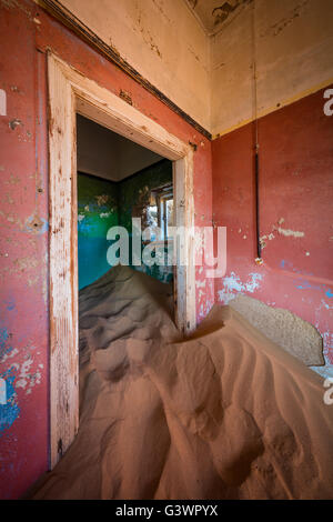 Kolmanskop (Afrikaans for Coleman's hill, German: Kolmannskuppe) is a ghost town in the Namib desert in southern Namibia,. Stock Photo