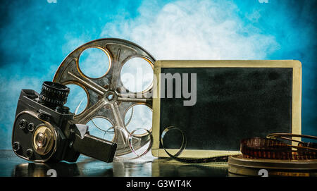 Retro film production accessories still life. Blank black board for copyspace. Concept of filmmaking. Smoke effect on background Stock Photo