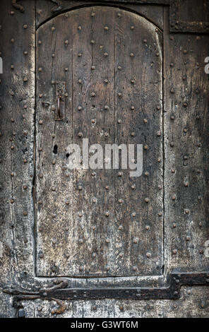 Old studded medieval wooden door. Stock Photo