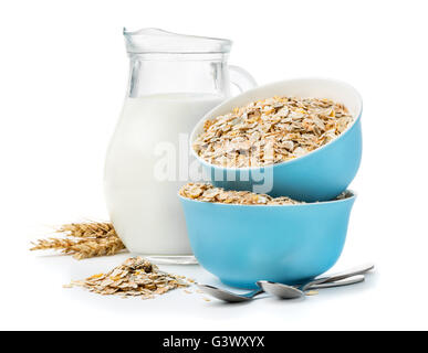 A healthy breakfast, a mixture of cereal flakes, muesli in blue bowls and milk jug isolated on white background Stock Photo