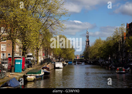 View along the Prinsengracht towards the Westerkerk in downtown Amsterdam, Netherlands in spring. Stock Photo