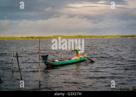 Fisherman in fishing boat on the lake, Marechal Deodoro, Maceio, Alagoas, Brazil Stock Photo