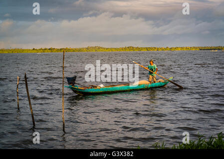 Fisherman in fishing boat on the lake, Marechal Deodoro, Maceio, Alagoas, Brazil Stock Photo