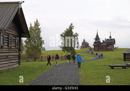 Various wooden buildings with the Church of the Transfiguration beyond,  Kizhi Island, Karelia Russia. Stock Photo