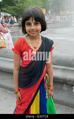 A 10 year old girl from Bangladesh in a traditional colorful dress in Washington Square Park in New York City. Stock Photo