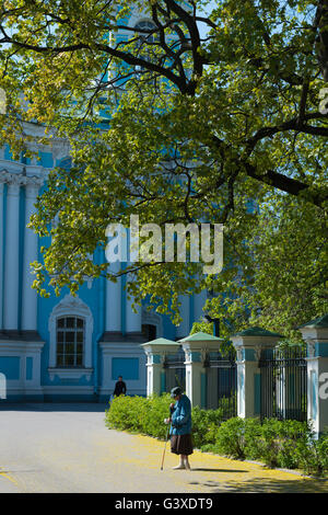 Old Woman Begging Outside St. Nicholas Naval Cathedral in St. Petersburg, Russia Stock Photo