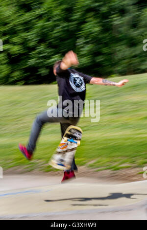 Skateboarders leaps, lunges, skateboard action, jumps, jumping stride, set-up, load, transition, pivot, takeoff, flight, and landing at the Moor Park recently opened professional Skate Park. Preston, Lancashire, UK. Stock Photo