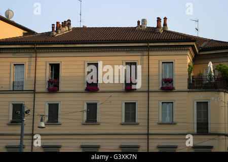 a beautifully elegant building with red flowers in milan Stock Photo