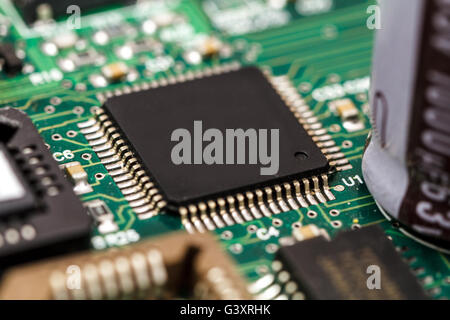 Printed circuit board with ICs, chip capacitors, and chip resistors. Stock Photo