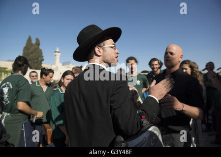 Jerusalem, Israel, Israel. 16th June, 2016. The Masorti Movement is a jewish-conservative religious group that believes in ploralism and deomcratic vision of Zionism. This morning the group tried to get together to a mutual prayer at the Western Wall as a step to demand a pluralist prayer space at the site. They we're protesting againts a haredi and religious youths and yeshiva students from the beginning to the end of the ceremony. Credit:  Danielle Shitrit/ZUMA Wire/Alamy Live News Stock Photo