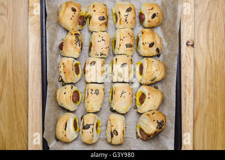 Baked sausages in a puff pastry - mini sausage rolls. Stock Photo