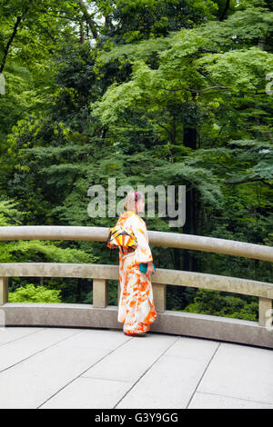 TOKYO - MAY, 2016: Young female wearing traditional Japanese outfit pose at Meiji Shrine at Yoyogi park on May 28, 2016 Stock Photo