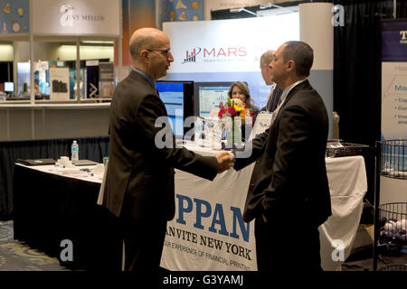 Businessmen shaking hands at an business expo exhibit - Washington, DC USA Stock Photo