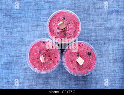 Blueberry blackcurrant popsicles in plastic cups, top view Stock Photo