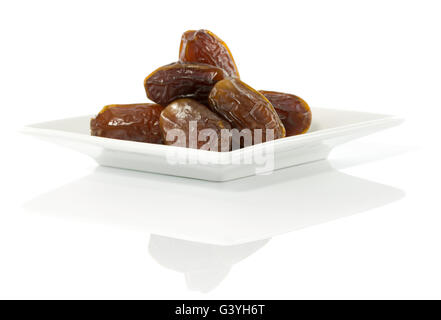 best quality of fresh tropical dates on white plate Stock Photo