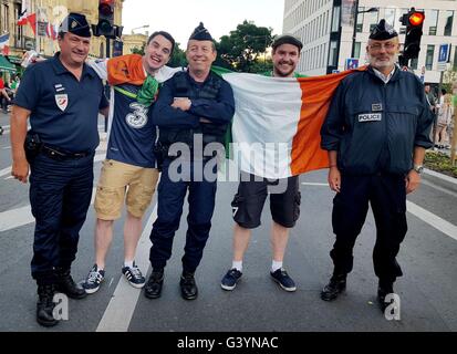 Irish fans Mark Davenport (left) and James Cooney from Dublin with French police officers in the picturesque French city of Bordeaux ahead of the Republic's match against Belgium on Saturday. Stock Photo