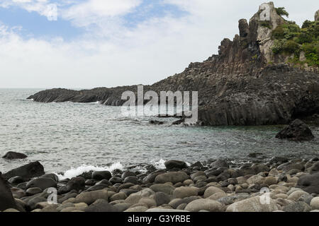 Rocky coastline near Daepo Jusangjeolli Cliff on Jeju Island in South Korea. Stock Photo