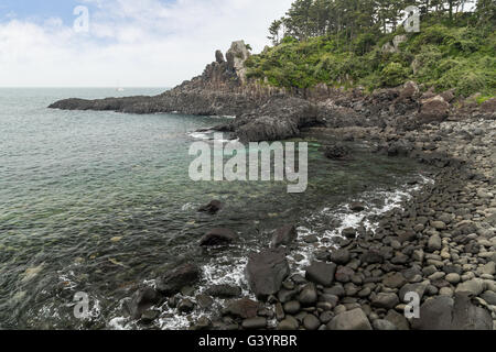 Rocky beach and coastline near Daepo Jusangjeolli Cliff on Jeju Island in South Korea. Stock Photo