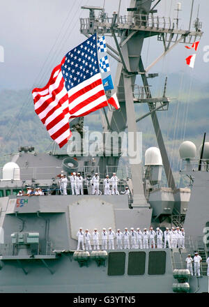 U.S. Navy Sailors line the rails aboard the Guided Missile Destroyer USS Paul Hamilton. Stock Photo