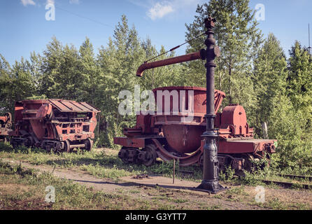 Old steel buckets to transport the molten iron, mounted on railway platforms on Mining and metallurgical plant Stock Photo