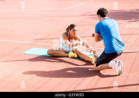 Woman training with personal trainer outdoor Stock Photo