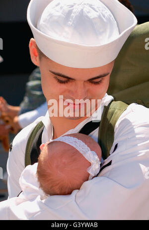 Sailor holds his baby daughter. Stock Photo