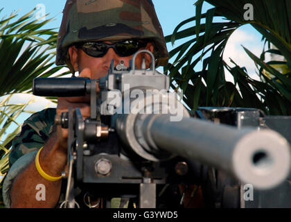Soldier demonstrates how to use a Browning M2 .50 caliber heavy machine gun. Stock Photo