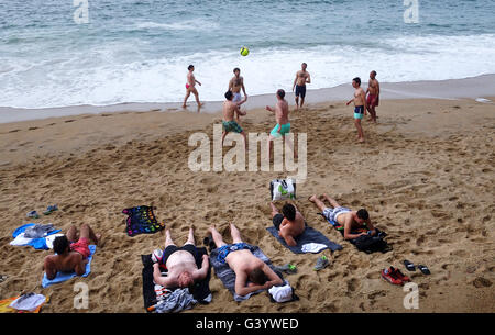 Men playing sport football on beach at Biarritz in France Stock Photo