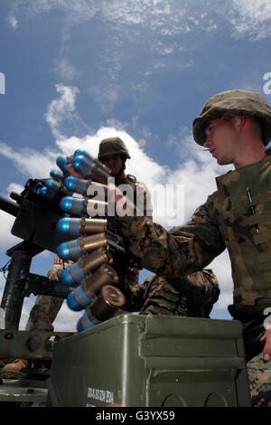 A marine loads an MK-19 40 mm grenade launcher. Stock Photo