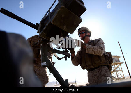 A soldier fires 40mm rounds with his MK-19 heavy machine gun. Stock Photo