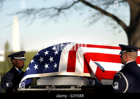 U.S. Air Force Honor Guardsmen transfer a casket from the caisson to the grave site. Stock Photo