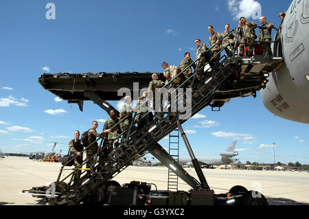 Airmen use the aircraft stairs portion of the Halvorson Air Stairs Kit-modified cargo loader. Stock Photo