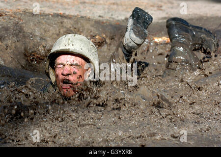 Basic cadet trainees attack the mud pit on the Jacks Valley assault course. Stock Photo