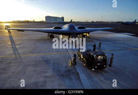 A B-2 Spirit stealth bomber is towed to a parking spot. Stock Photo