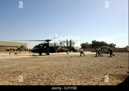 Soldiers rush a simulated casualty to a UH-60 Blackhawk helicopter. Stock Photo