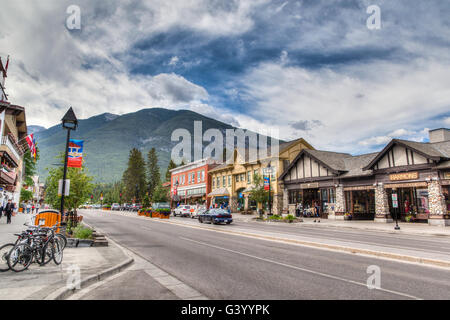 Banff, Canada - July 3, 2014: Shoppers stroll along the many retail shops along Banff Avenue in the Banff National Park. Stock Photo