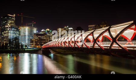 Night view of Calgary's Peace Bridge. The bridge features a red and white helix design and was opened in March 2012. Stock Photo