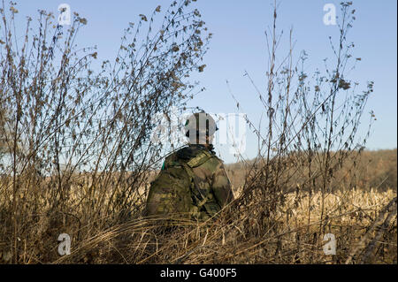 A member of the French Foreign Legion stands on look out after parachuting north of Tarbes, France, during exercise 2007 Stock Photo