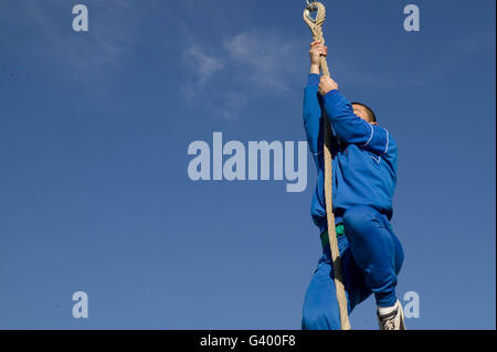 French Foreign Legion trainee in sweat pants climbing rope during exercise 2007 at the force's headquarters in Aubagne; France Stock Photo