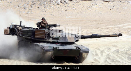 An M1-A1 Abrams Main Battle Tank rumbles across a live-fire range. Stock Photo