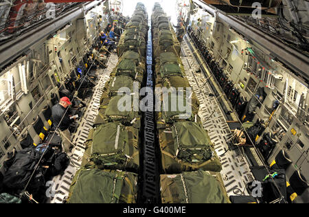 A C-17 Globemaster III cargo aircraft is loaded with 40 pallets of relief supplies. Stock Photo